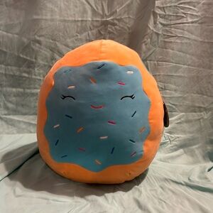 A cute cookie Squishmallow with blue frosting and sprinkles. Meet Erissa!